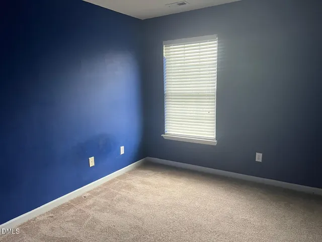 a white toilet sitting next to a white sink and vanity