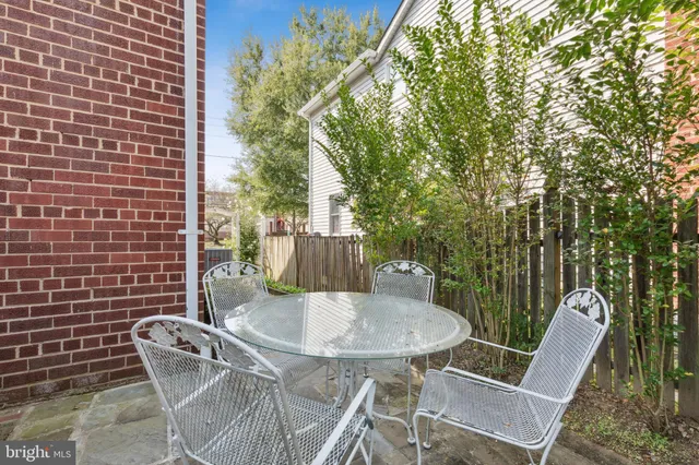 a swimming pool with an outdoor space and seating area