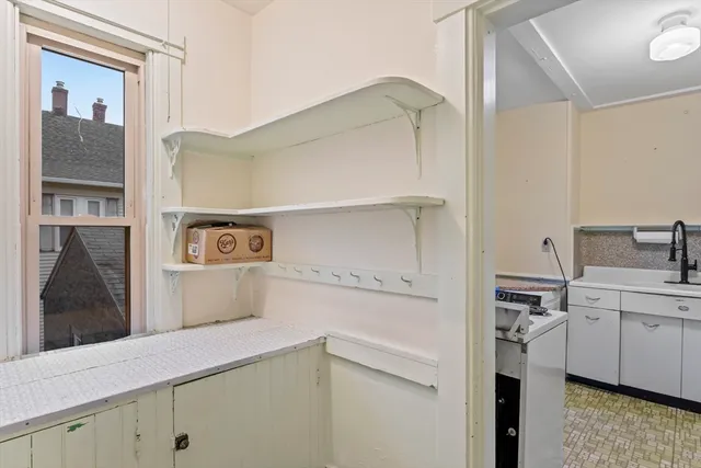 a kitchen with a refrigerator and a sink