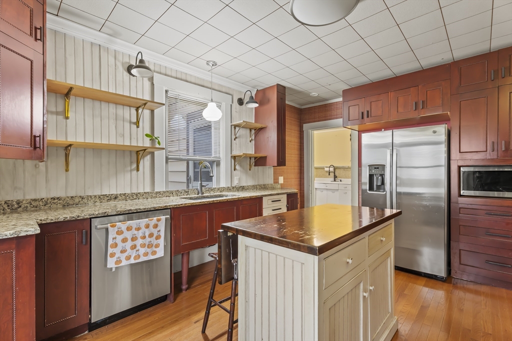 216 Walnut Street Clinton, MA 01510 - Photo 13 of 40 a kitchen with stainless steel appliances granite countertop a sink a stove and a refrigerator
