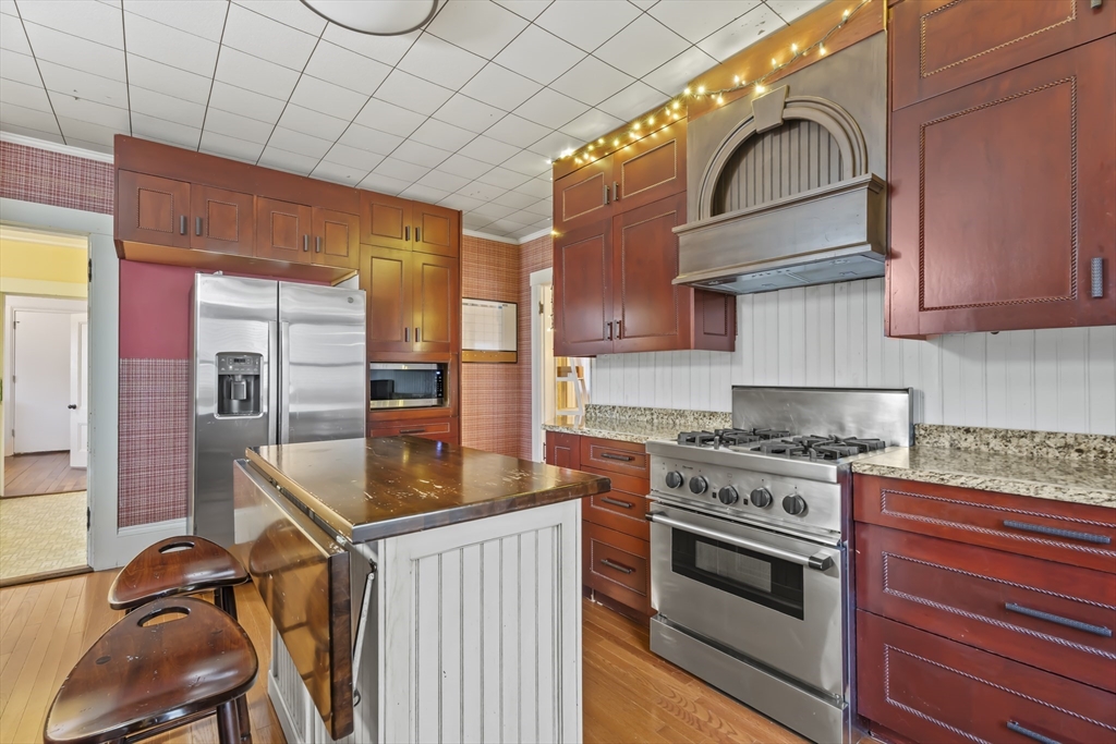216 Walnut Street Clinton, MA 01510 - Photo 14 of 40 a kitchen with stainless steel appliances granite countertop a stove a sink and a microwave