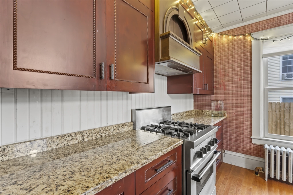 216 Walnut Street Clinton, MA 01510 - Photo 15 of 40 a kitchen with granite countertop a stove a sink and a microwave