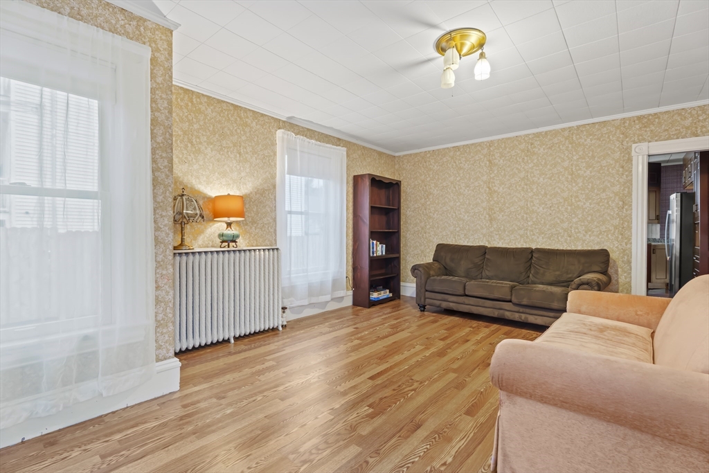 216 Walnut Street Clinton, MA 01510 - Photo 18 of 40 a living room with furniture and a wooden floor