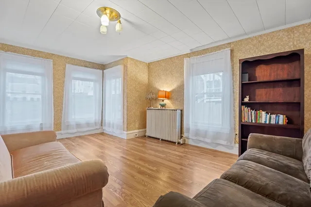 a living room with furniture and a chandelier