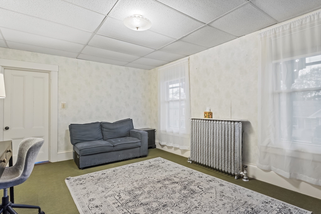 216 Walnut Street Clinton, MA 01510 - Photo 21 of 40 a living room with furniture and a rug