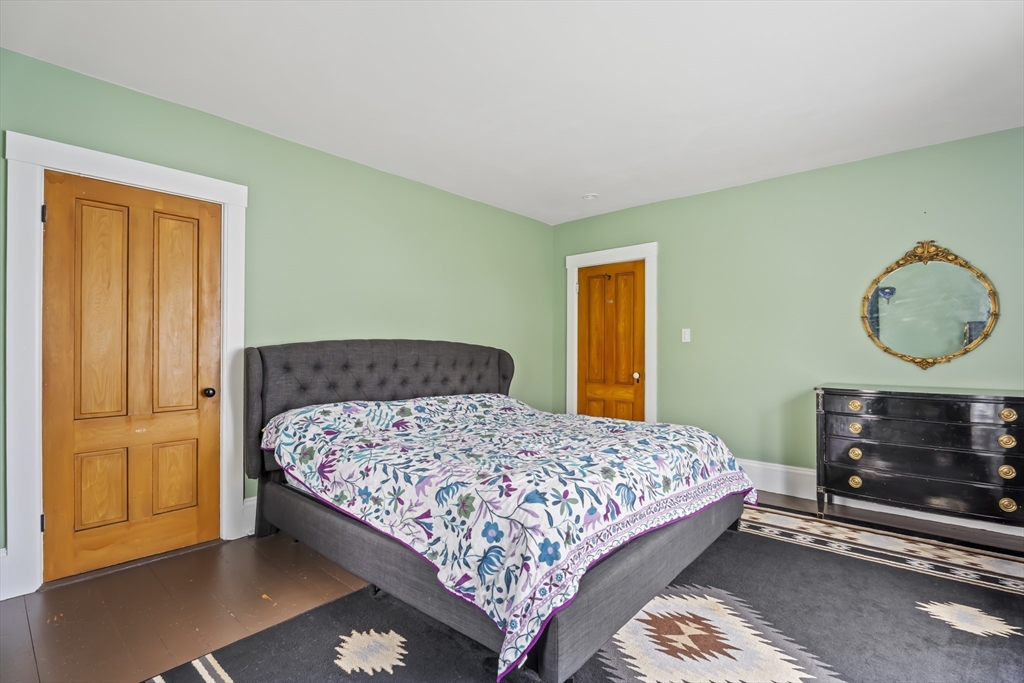 216 Walnut Street Clinton, MA 01510 - Photo 24 of 40 a bedroom with a bed a dresser and a window