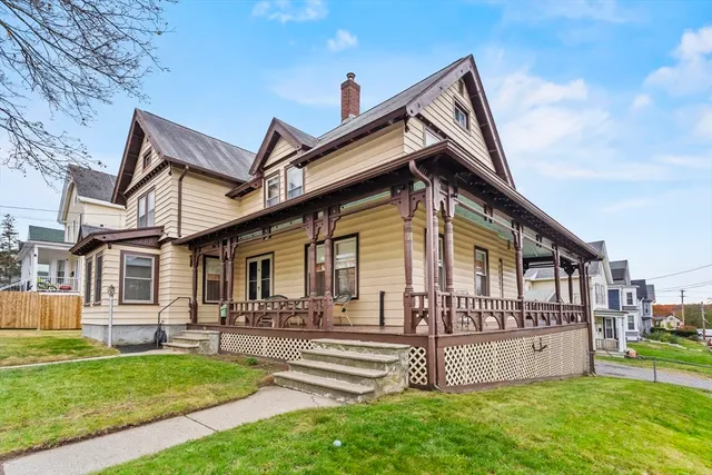 a front view of a house with a yard table and chairs