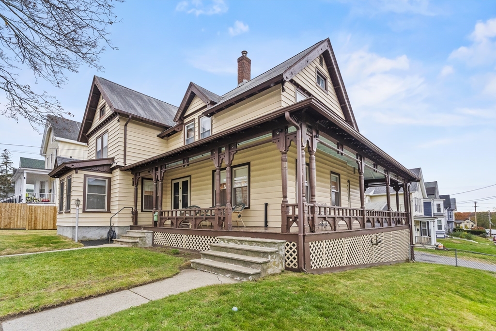 216 Walnut Street Clinton, MA 01510 - Photo 3 of 40 a front view of a house with a yard table and chairs