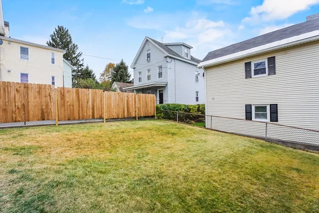 a view of a house with backyard and sitting area