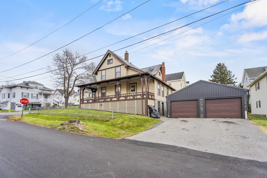 216 Walnut Street Clinton, MA 01510 - Photo 4 of 40 a front view of a house with a yard and garage