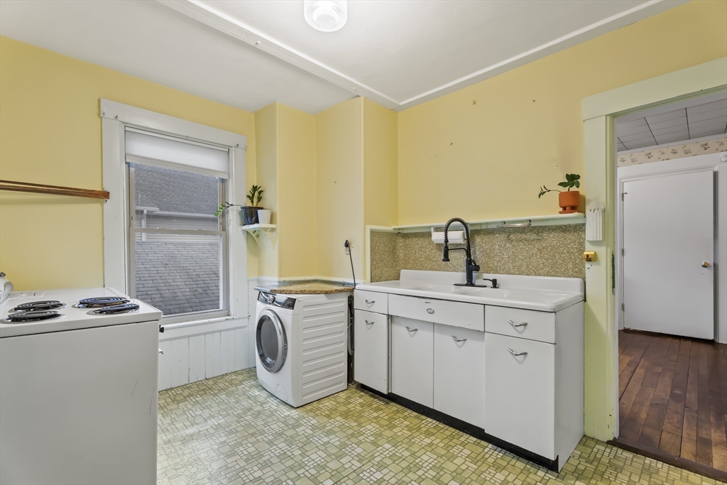 216 Walnut Street Clinton, MA 01510 - Photo 10 of 40 a kitchen with sink a refrigerator and cabinets