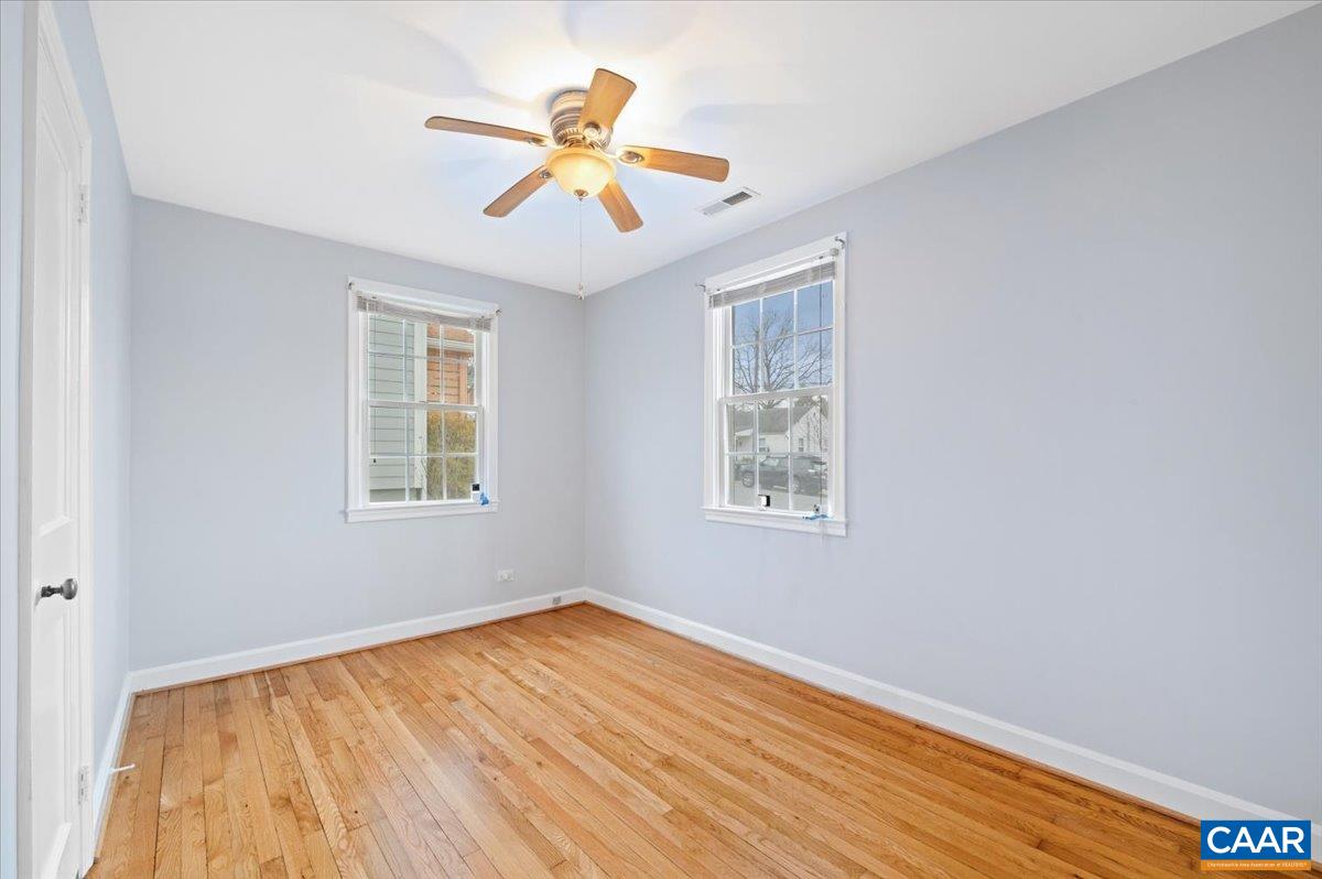 915 Altavista Avenue Charlottesville, VA 22902 - Photo 6 of 9 a view of an empty room with wooden floor and a window
