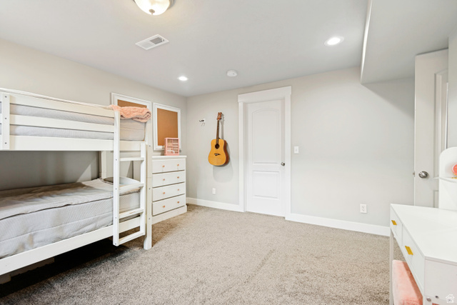 983 West 1550th Street South Springville, UT 84663 - Photo 35 of 43 Spacious room featuring neutral carpeting, light gray walls, white trim, recessed lighting, and a white paneled door.