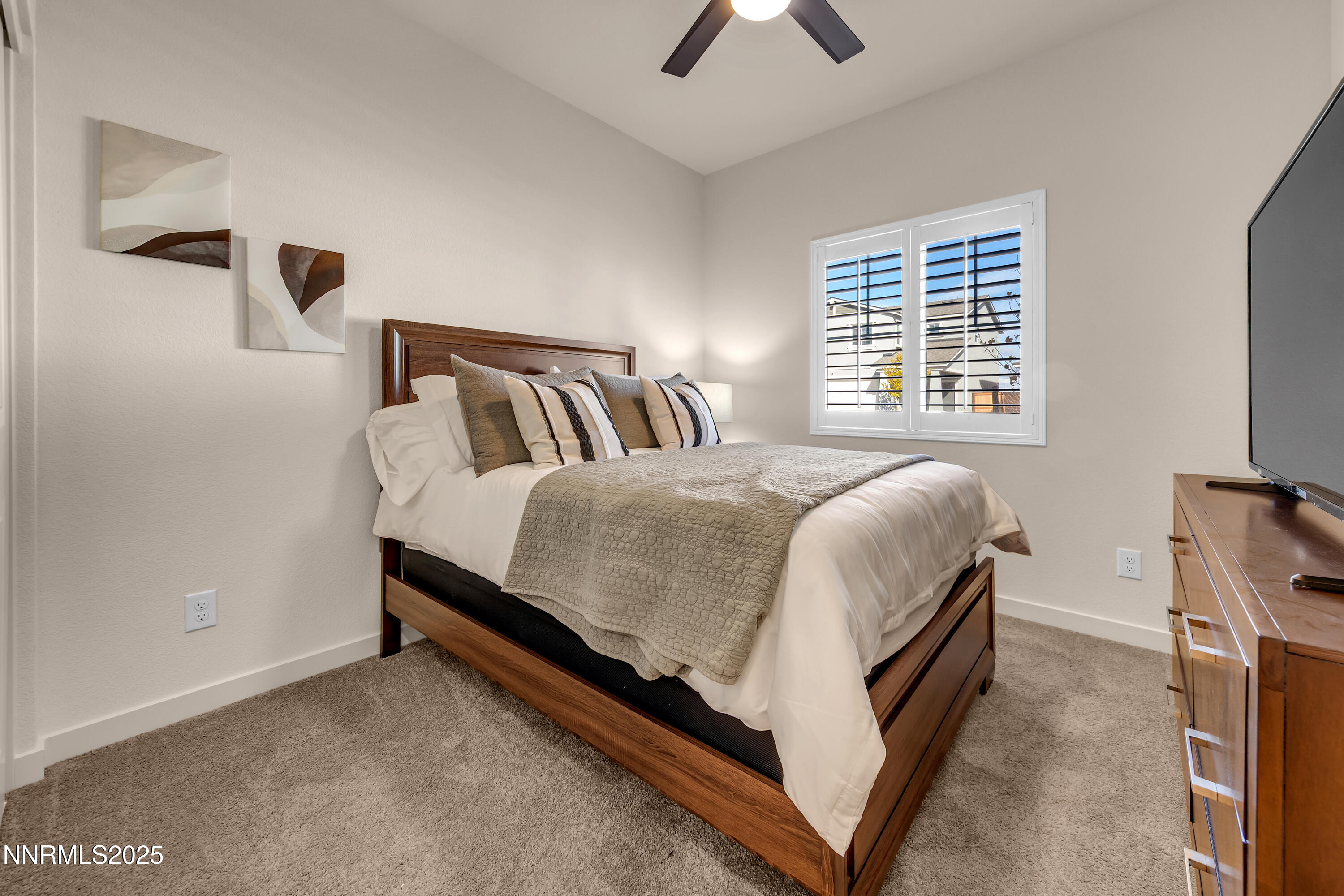 7754 Wandering Way Reno, NV 89506 - Photo 16 of 37 a bed room with a bed and a tv