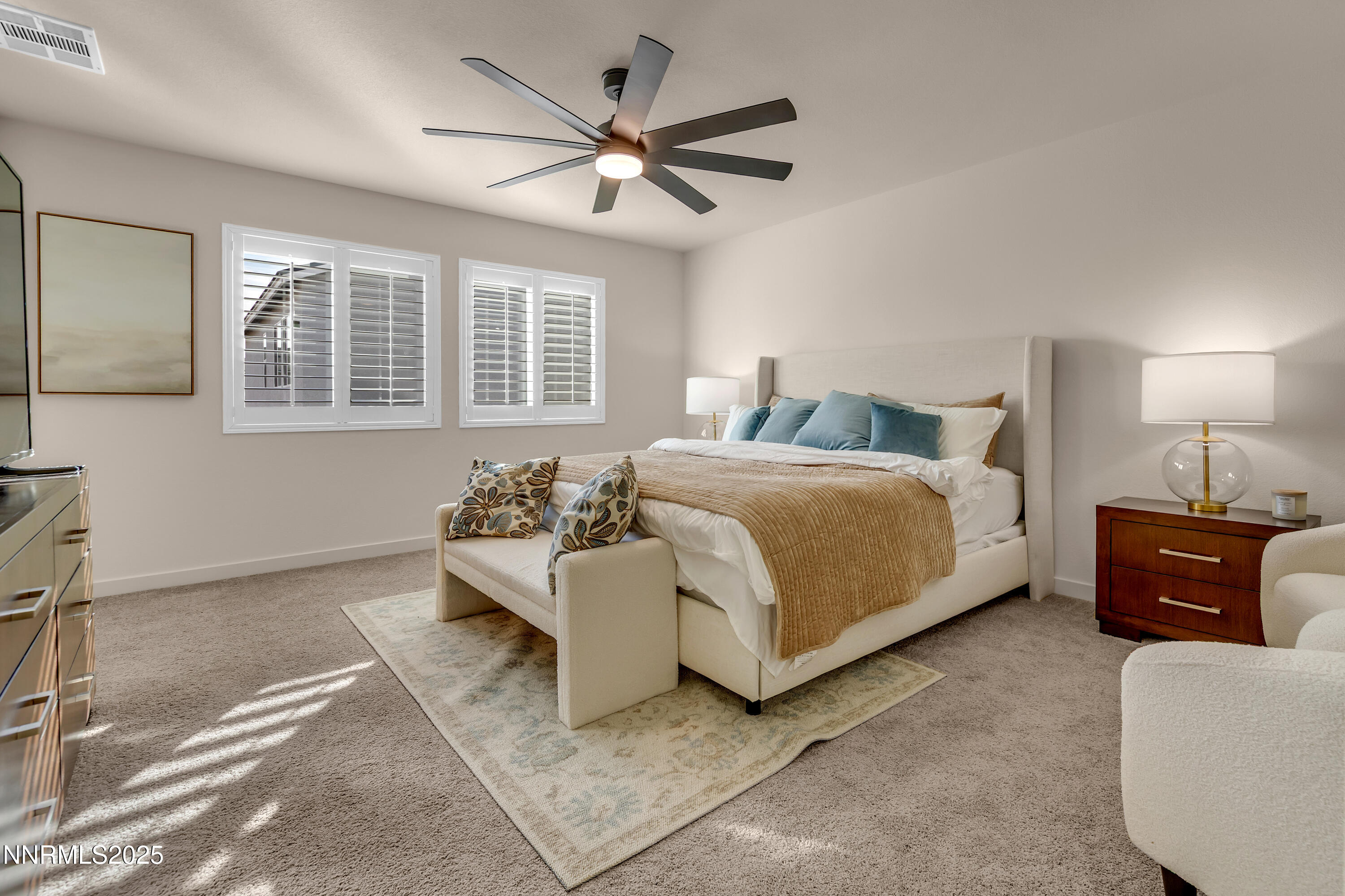 7754 Wandering Way Reno, NV 89506 - Photo 22 of 37 a bedroom with a bed and a couch