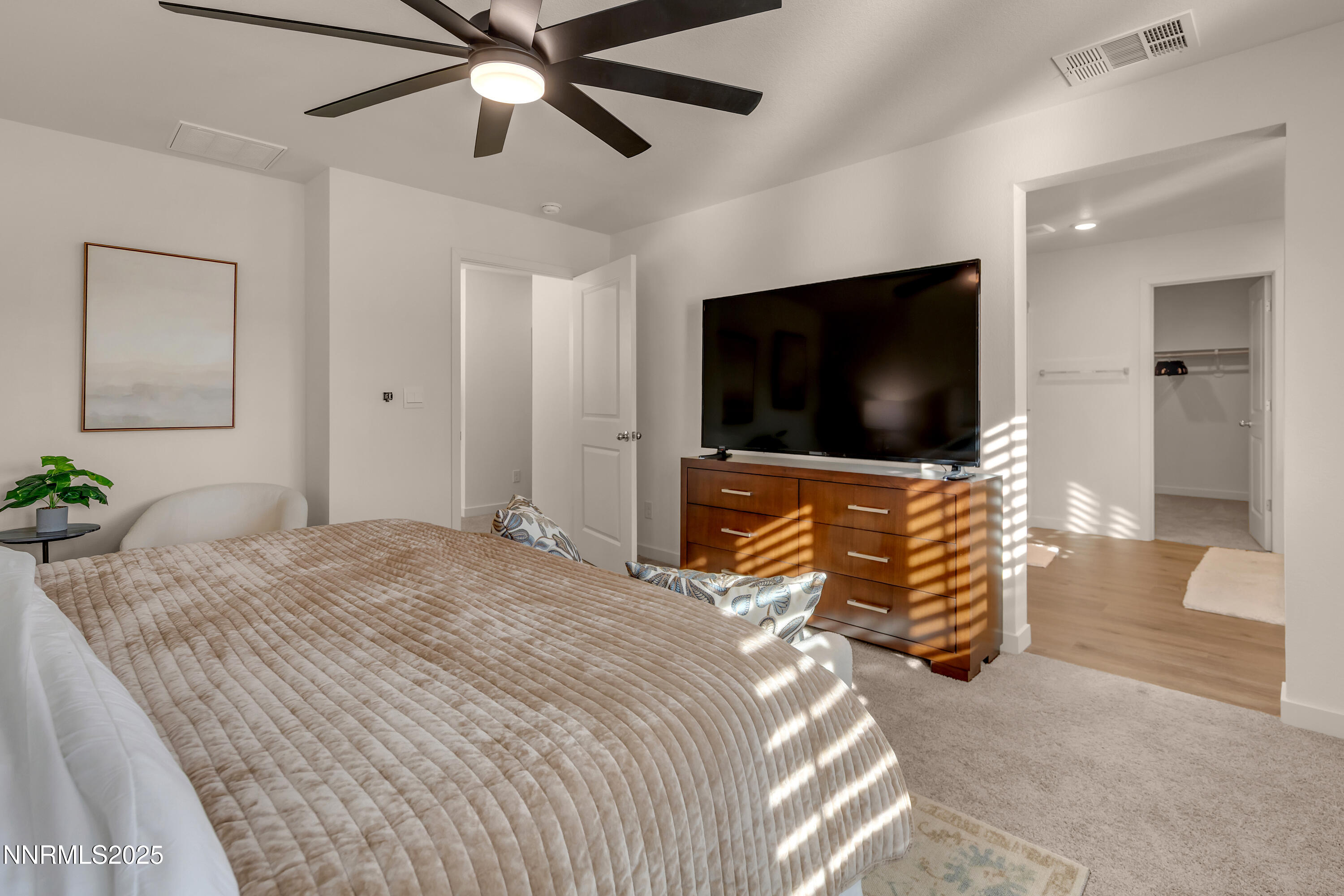 7754 Wandering Way Reno, NV 89506 - Photo 24 of 37 a bedroom with a bed and a flat screen tv