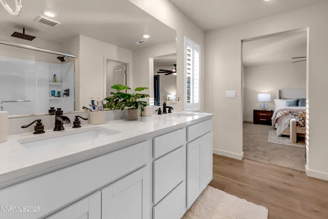 a bathroom with a sink double vanity granite and a mirror