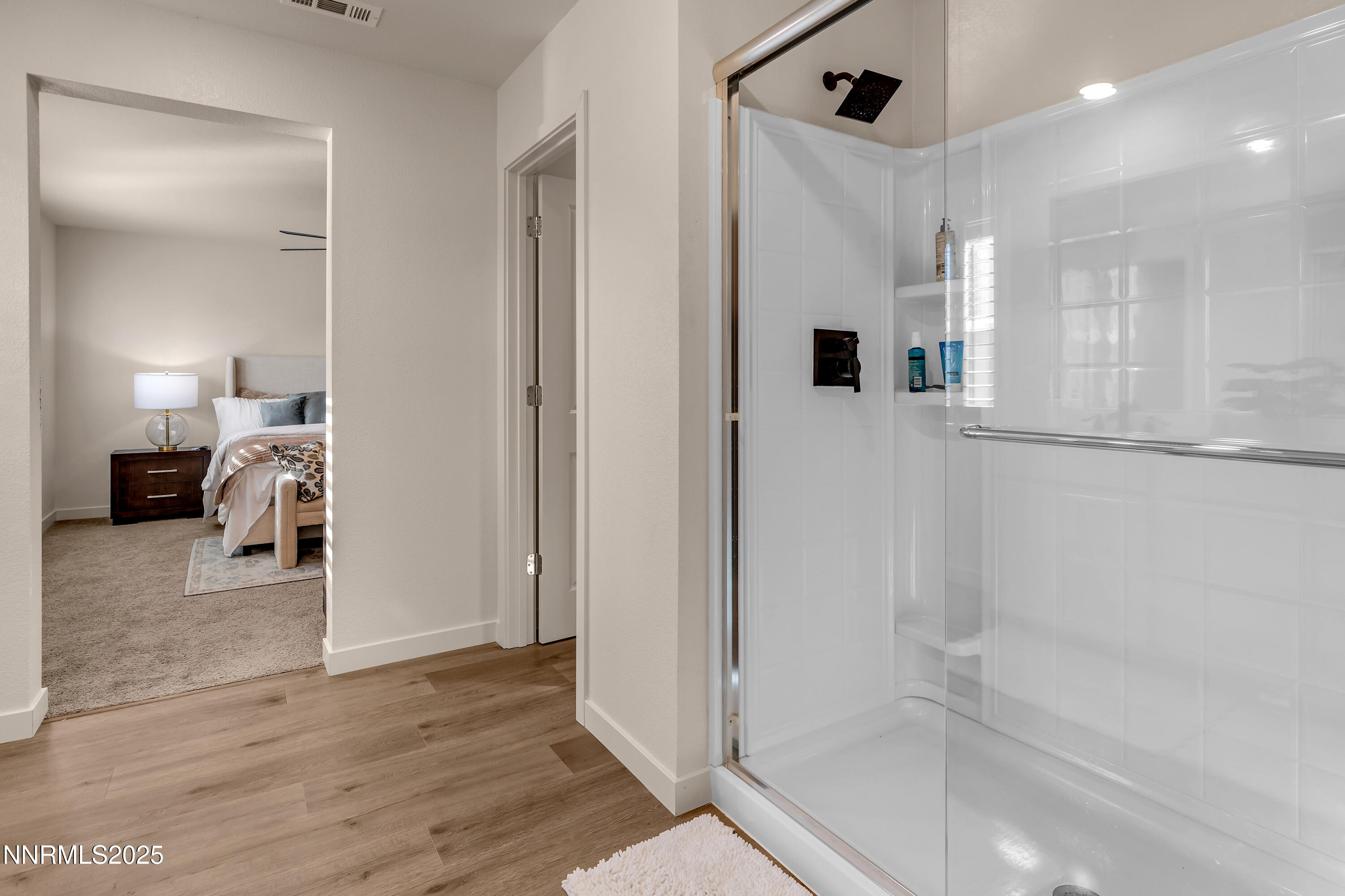 7754 Wandering Way Reno, NV 89506 - Photo 28 of 37 a bathroom with a tub shower and a mirror