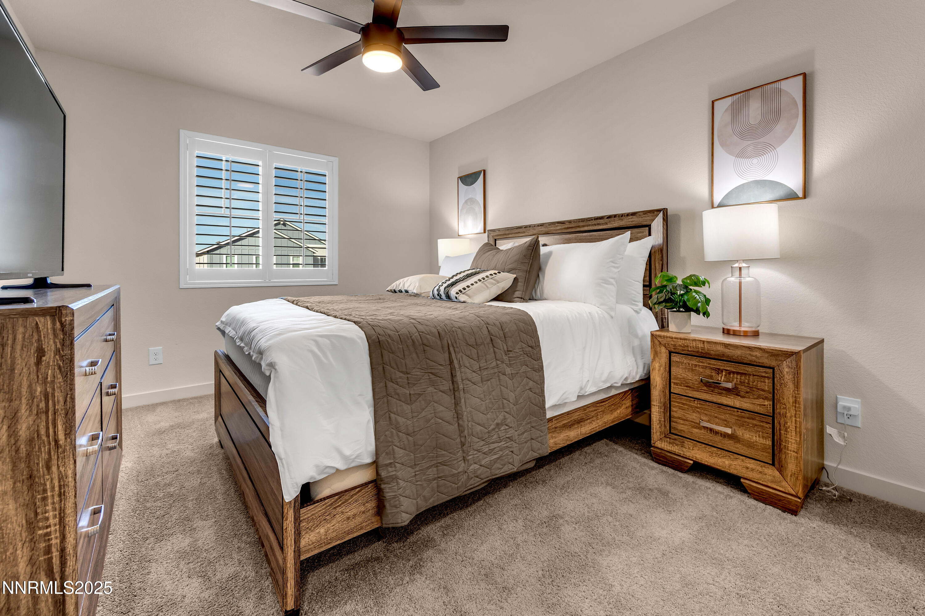 7754 Wandering Way Reno, NV 89506 - Photo 29 of 37 a bedroom with a bed and a chandelier