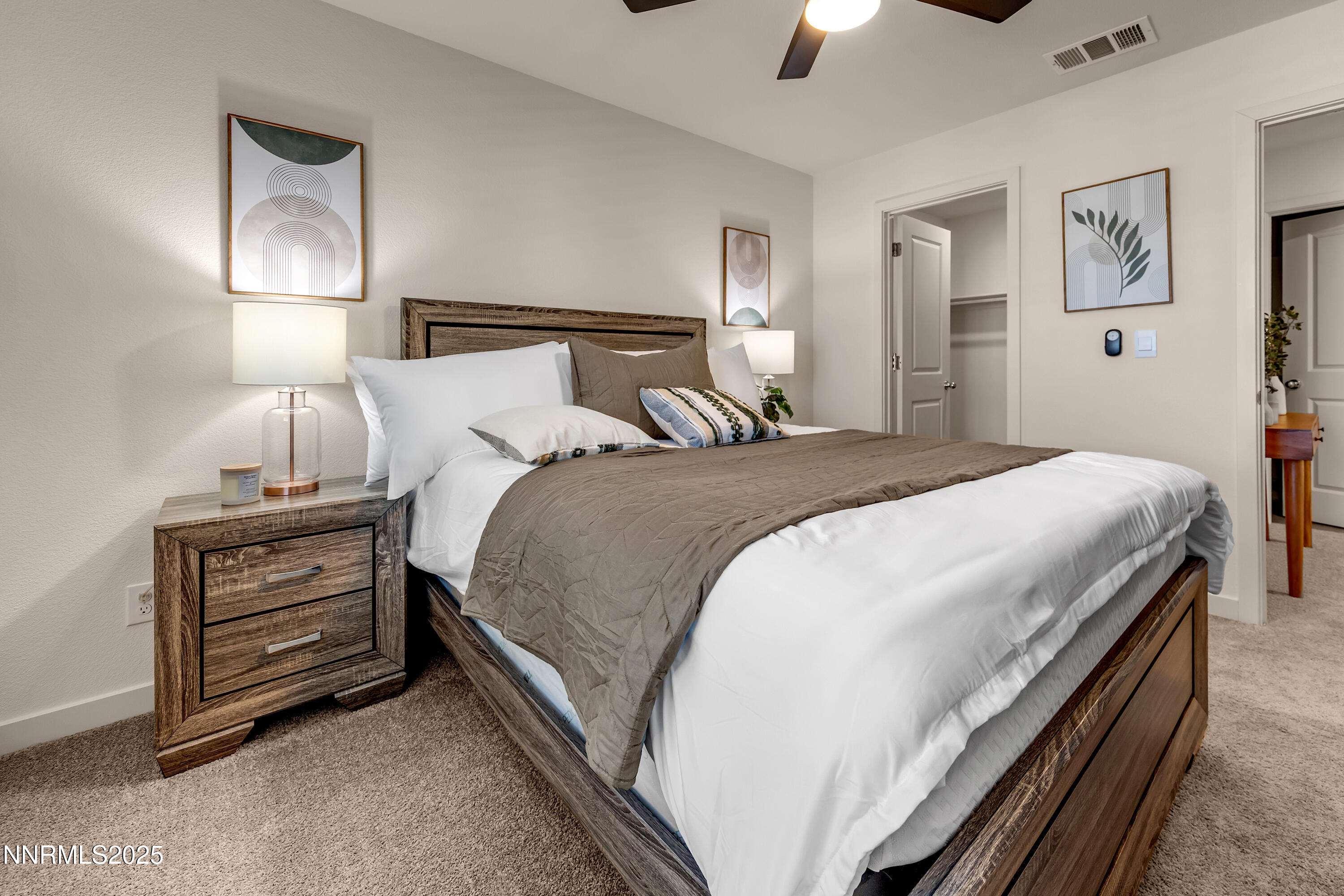 7754 Wandering Way Reno, NV 89506 - Photo 30 of 37 a bedroom with a bed and a chandelier