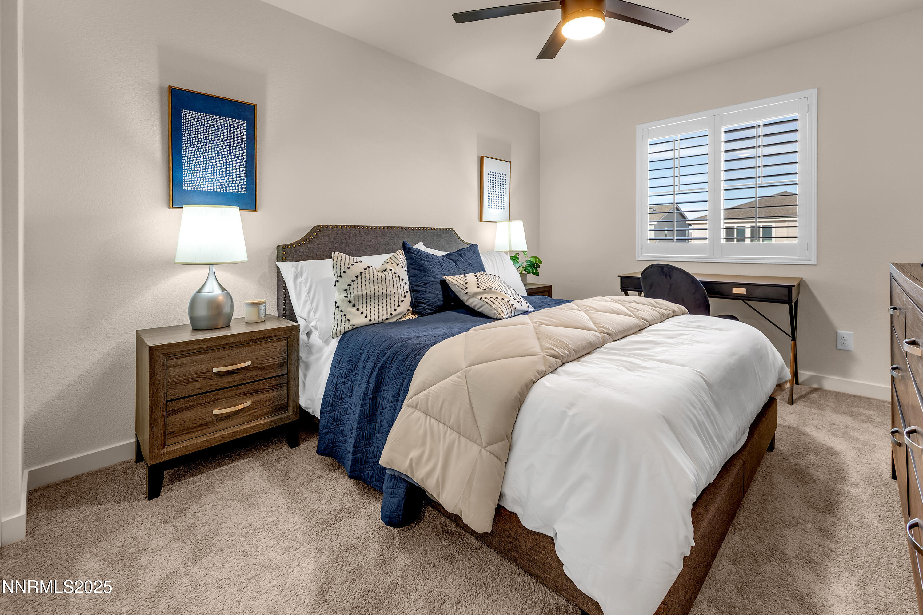 7754 Wandering Way Reno, NV 89506 - Photo 31 of 37 a bedroom with a bed and a chandelier