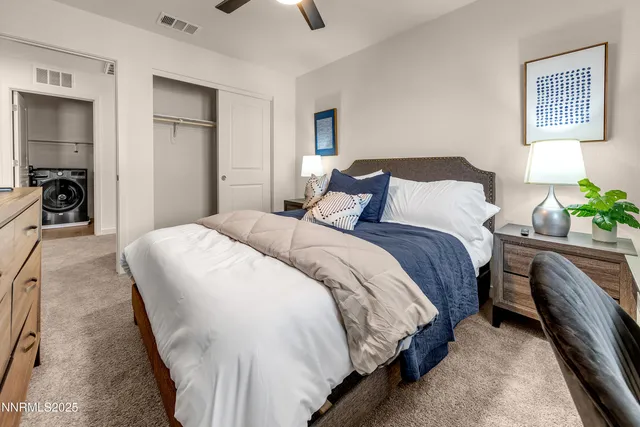 a bedroom with bed and a chandelier