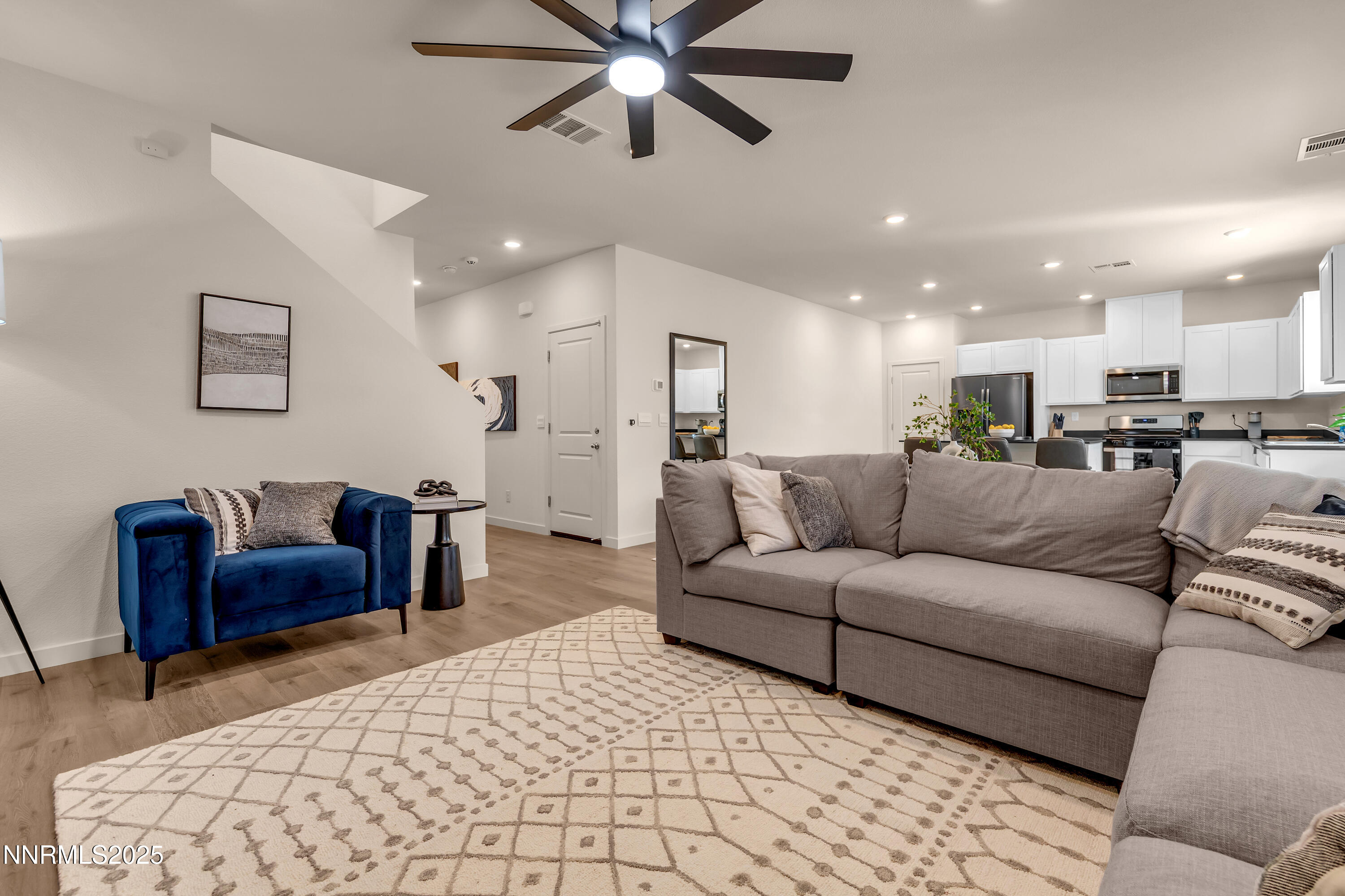 7754 Wandering Way Reno, NV 89506 - Photo 4 of 37 a living room with furniture and a chandelier