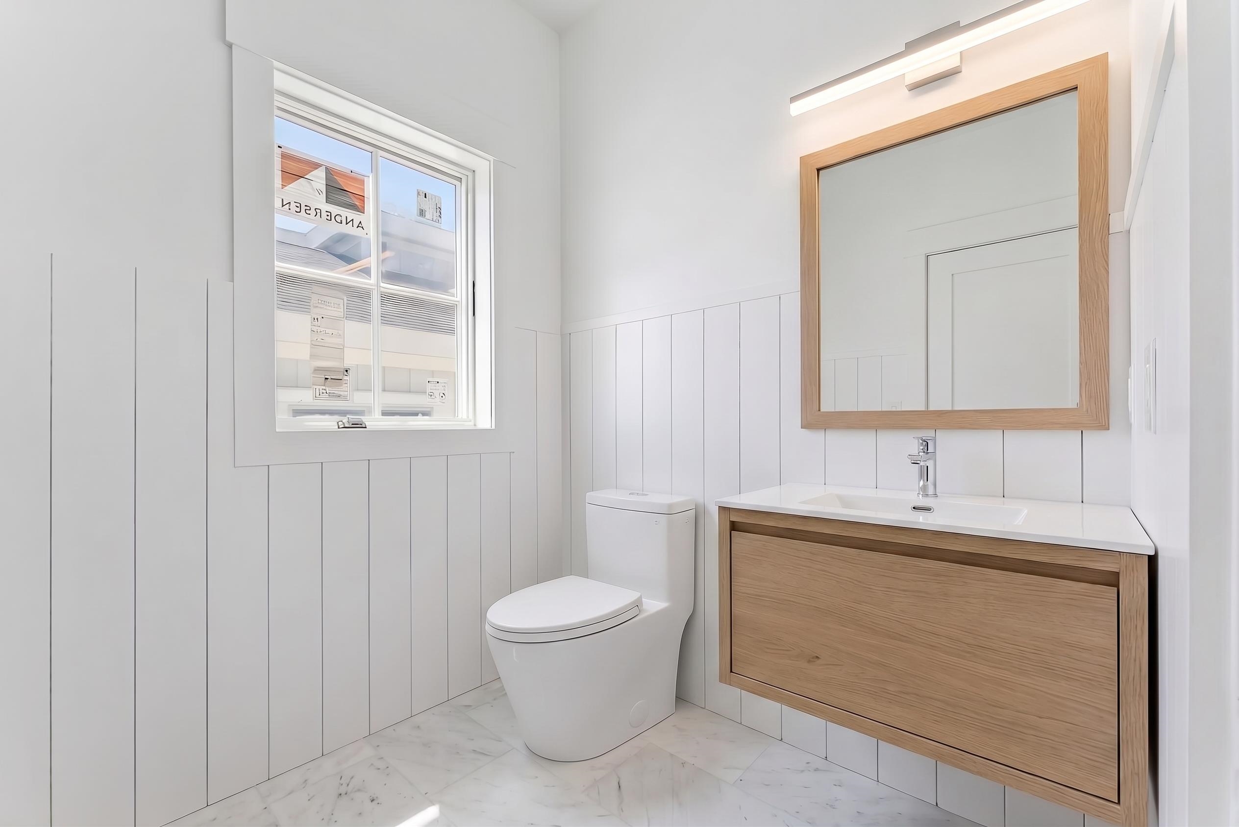 8527 3rd Stone Harbor, NJ 08247 - Photo 12 of 28 a bathroom with a toilet sink vanity and mirror