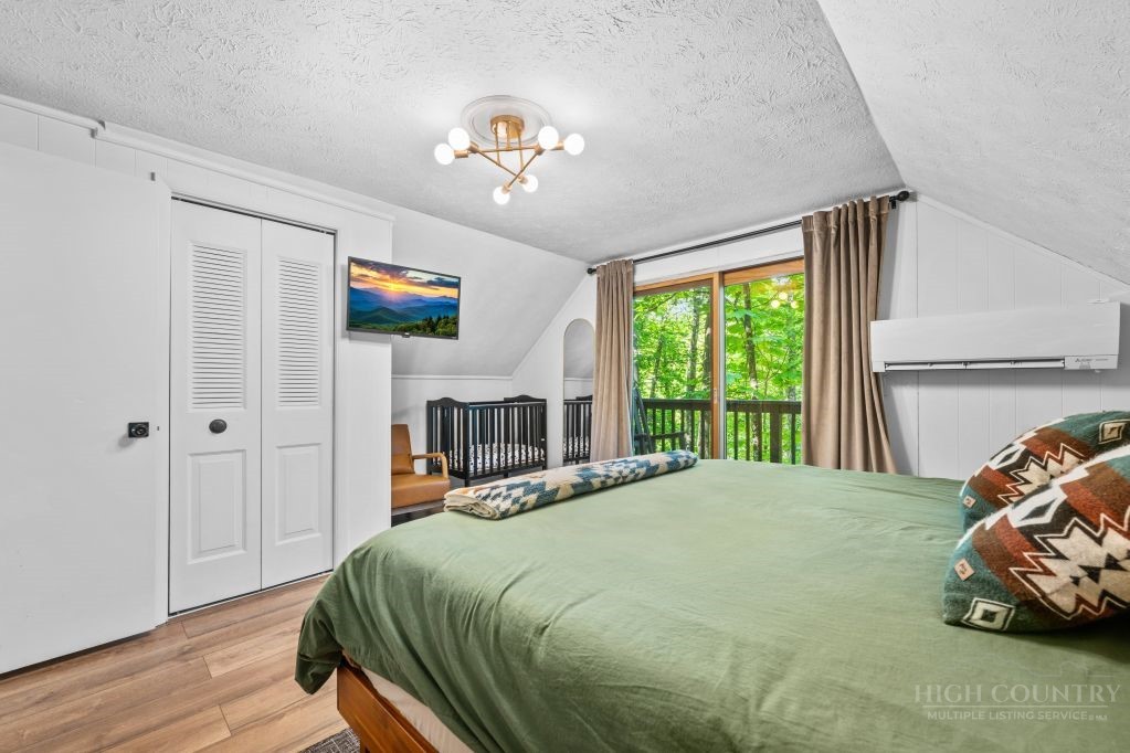 216 Saddle Lane Deep Gap, NC 28618 - Photo 18 of 44 a bedroom with a bed and a window