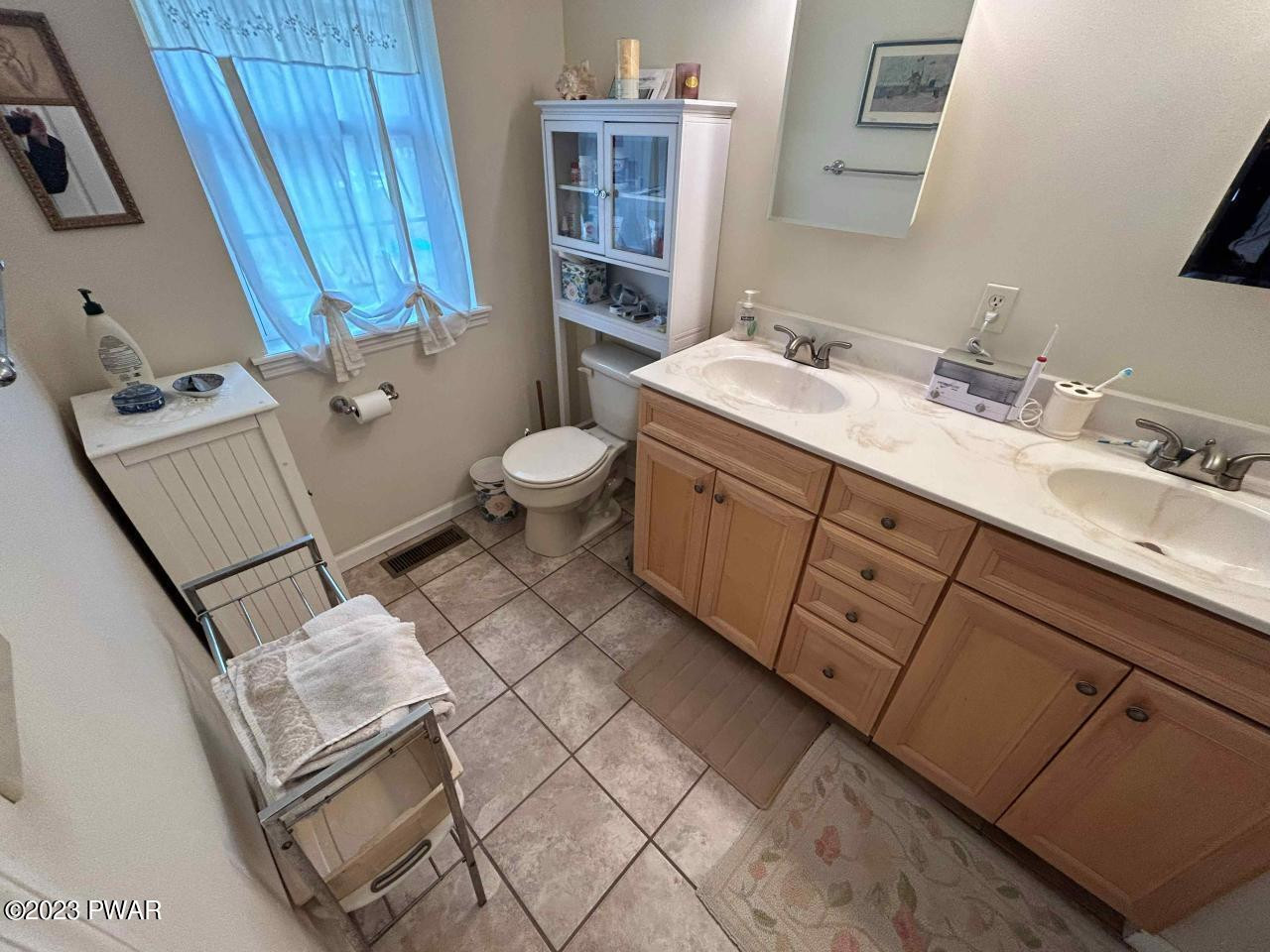 131 Maple Ridge Road Milford, PA 18337 - Photo 28 of 54 a bathroom with a sink mirror vanity and toilet