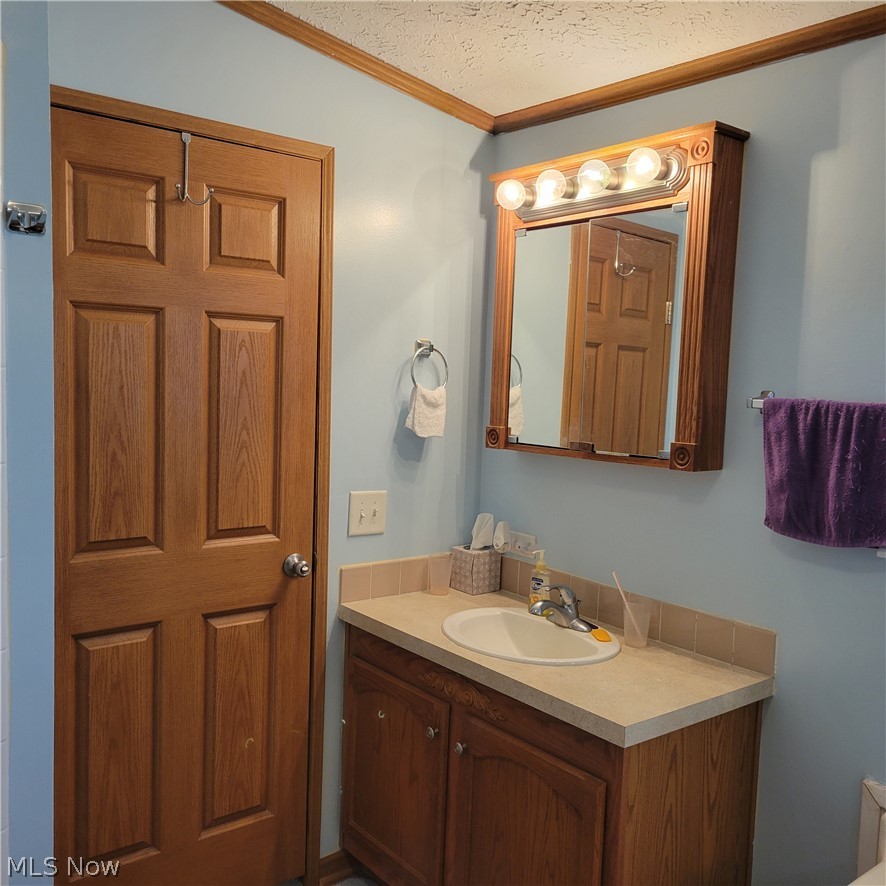 9531 McCormick Road Southwest Newcomerstown, OH 43832 - Photo 2 of 44 Bathroom featuring a textured ceiling and vanity