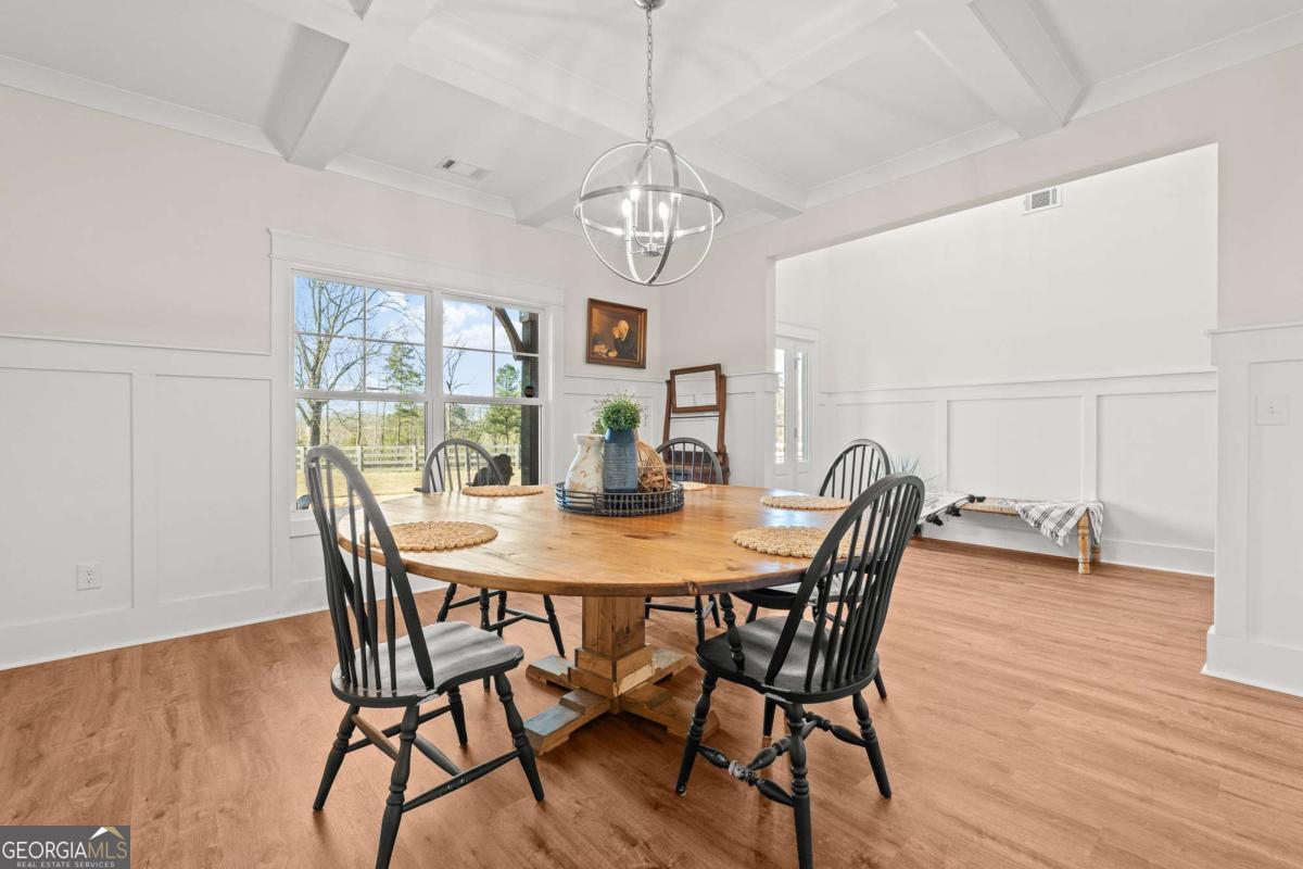 1515 Pleasant Ridge Road Carrollton, GA 30117 - Photo 12 of 72 a view of a dining room with furniture and wooden floor