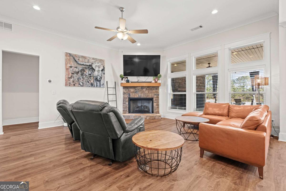 1515 Pleasant Ridge Road Carrollton, GA 30117 - Photo 15 of 72 a living room with furniture a flat screen tv and a fireplace