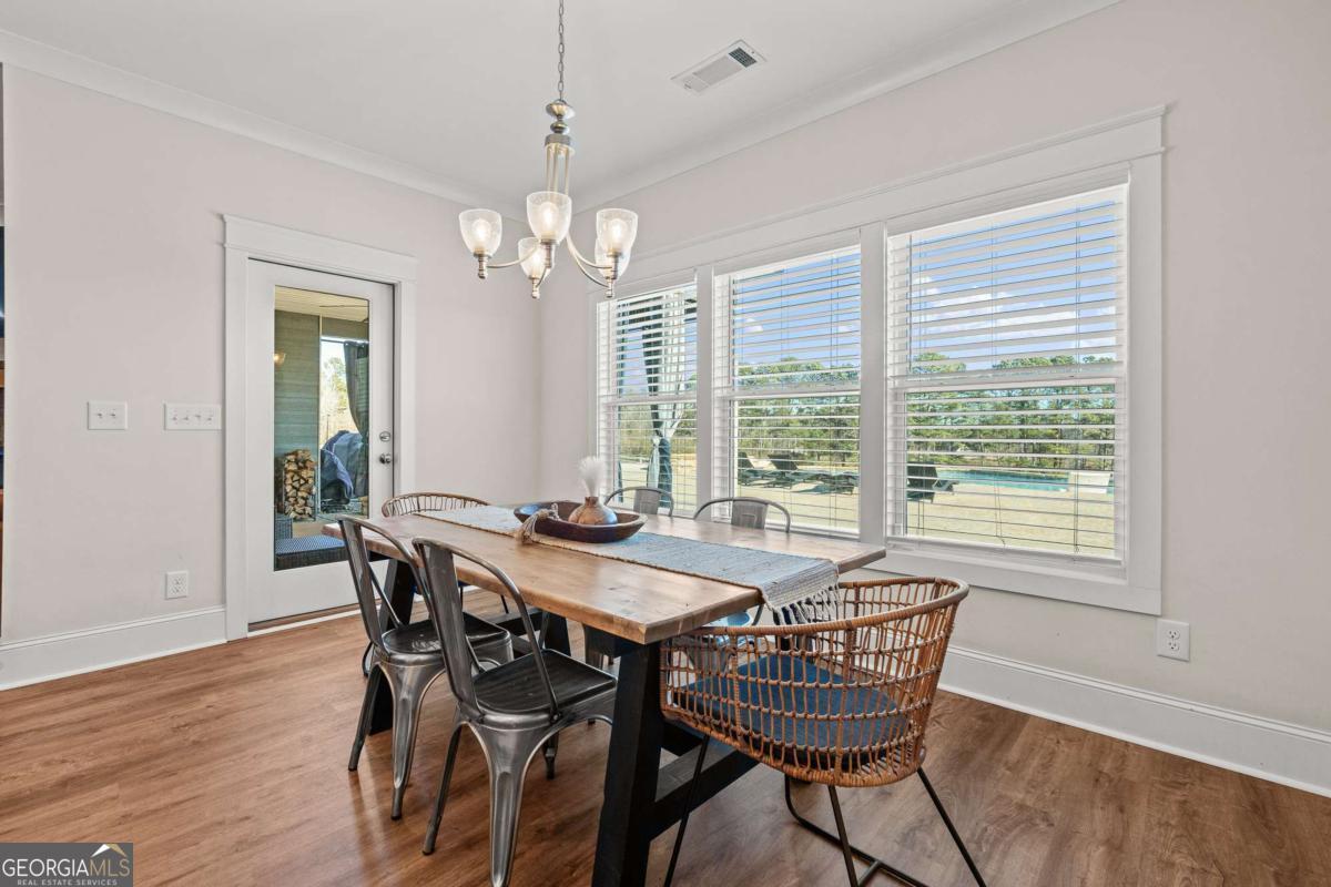 1515 Pleasant Ridge Road Carrollton, GA 30117 - Photo 23 of 72 a view of a dining room with furniture window and wooden floor