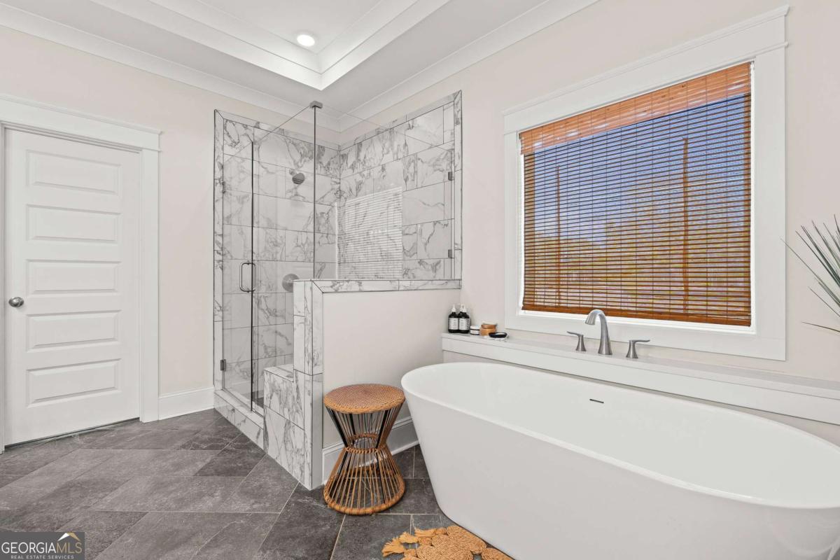 1515 Pleasant Ridge Road Carrollton, GA 30117 - Photo 28 of 72 a spacious bathroom with a bathtub and a shower