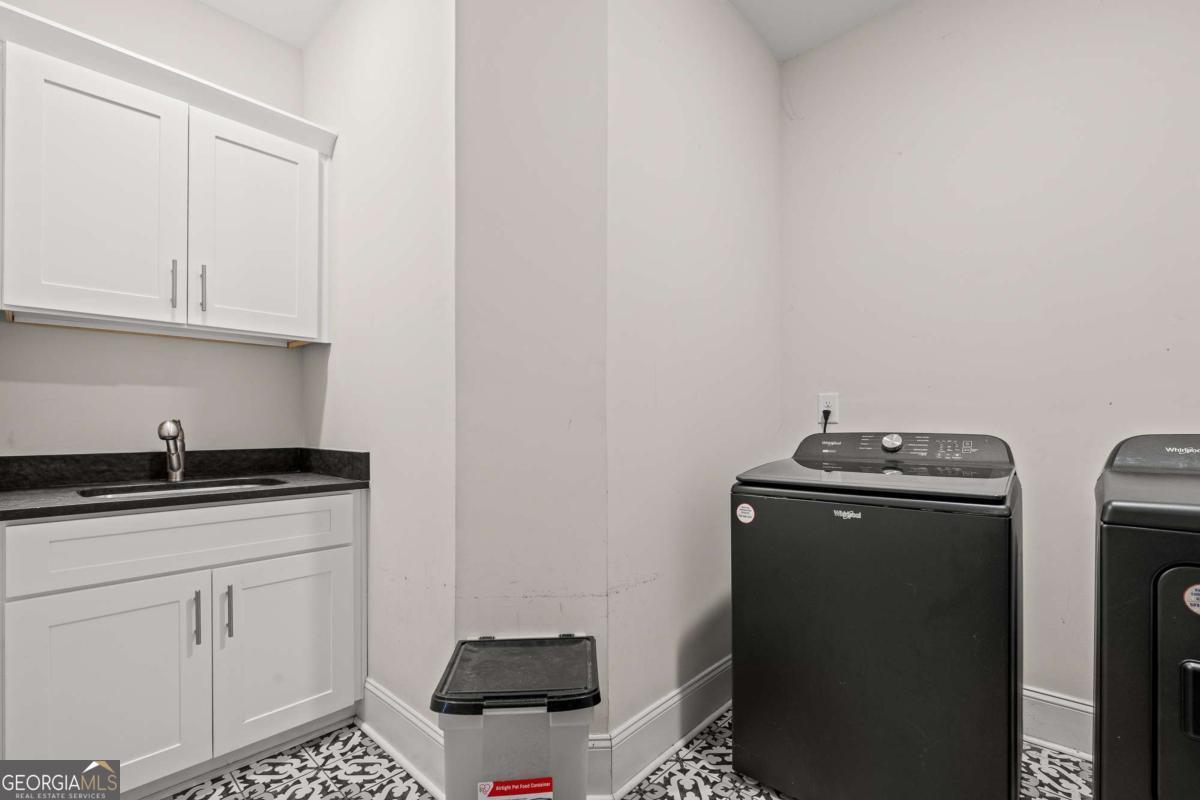 1515 Pleasant Ridge Road Carrollton, GA 30117 - Photo 36 of 72 a kitchen with stainless steel appliances granite countertop a sink stove and cabinets