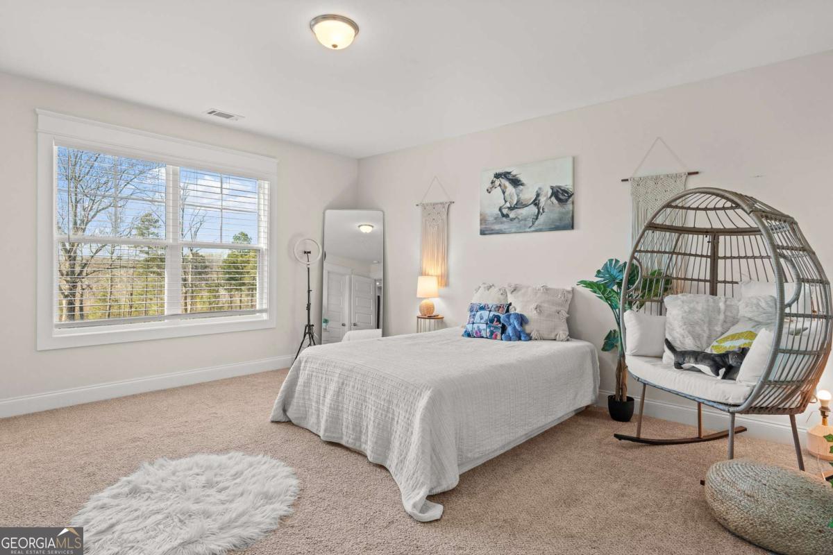 1515 Pleasant Ridge Road Carrollton, GA 30117 - Photo 37 of 72 a bedroom with a bed and a window