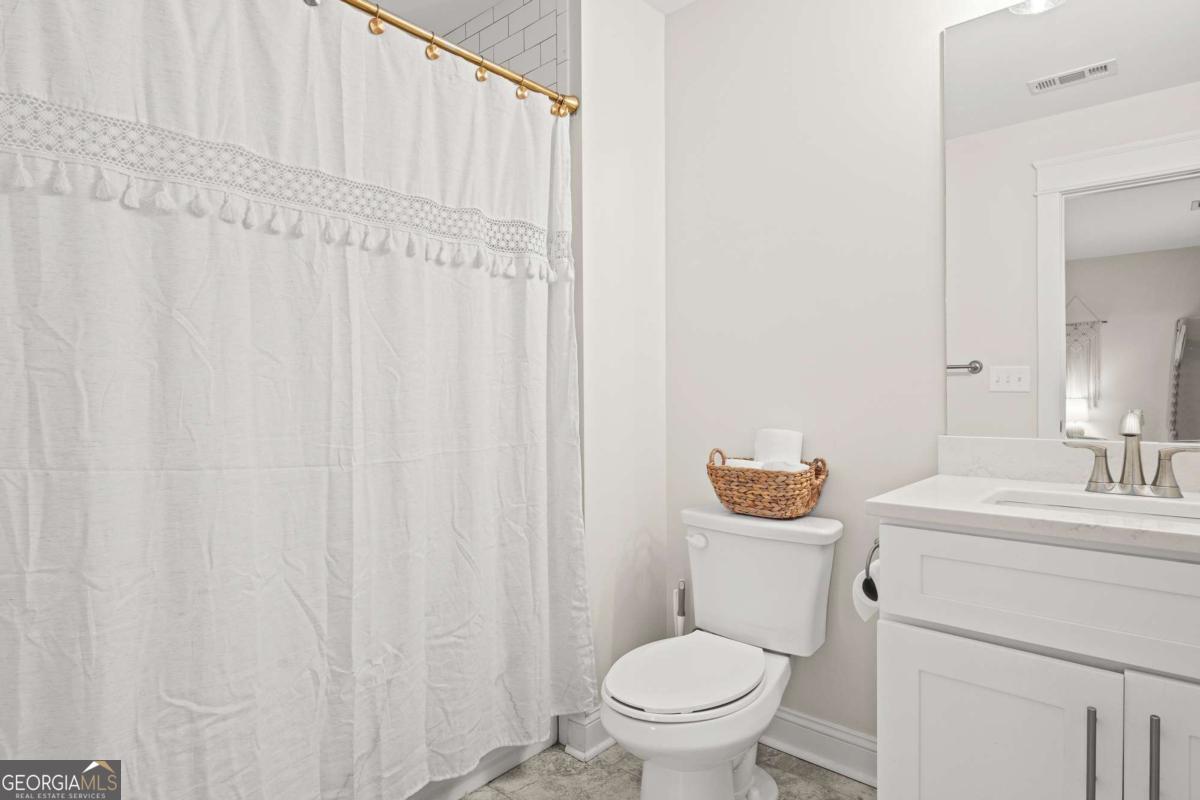1515 Pleasant Ridge Road Carrollton, GA 30117 - Photo 39 of 72 a bathroom with a sink a toilet and a mirror