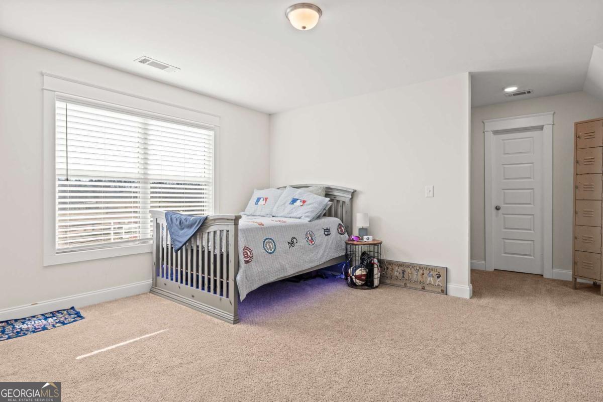 1515 Pleasant Ridge Road Carrollton, GA 30117 - Photo 40 of 72 a bedroom with a bed and a window