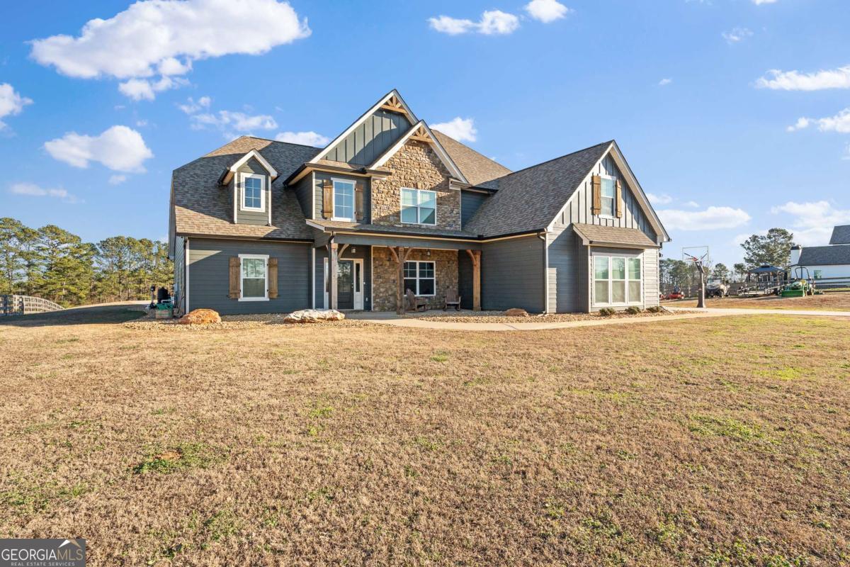 1515 Pleasant Ridge Road Carrollton, GA 30117 - Photo 4 of 72 a front view of a house with a garden