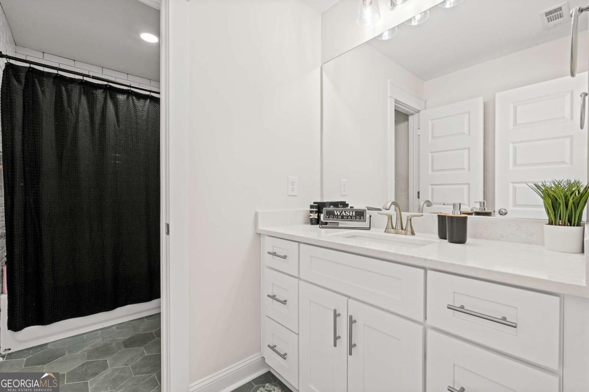 1515 Pleasant Ridge Road Carrollton, GA 30117 - Photo 42 of 72 a view of bathroom with a sink and mirror