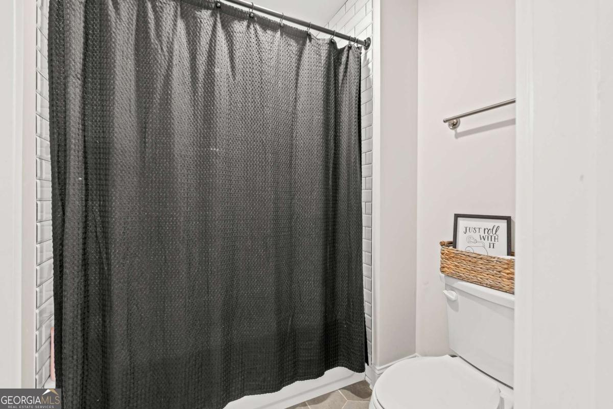 1515 Pleasant Ridge Road Carrollton, GA 30117 - Photo 43 of 72 a bathroom with a toilet and a shower