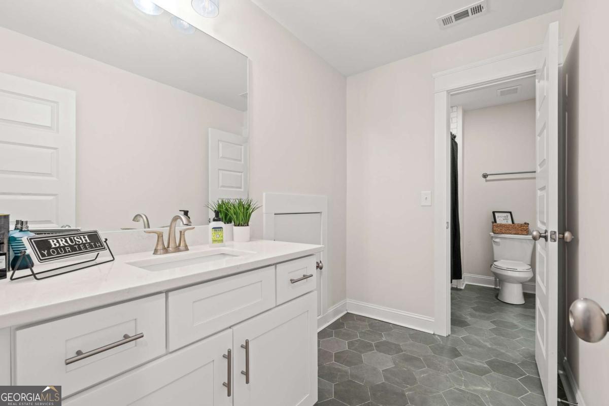 1515 Pleasant Ridge Road Carrollton, GA 30117 - Photo 44 of 72 a bathroom with a sink and a toilet