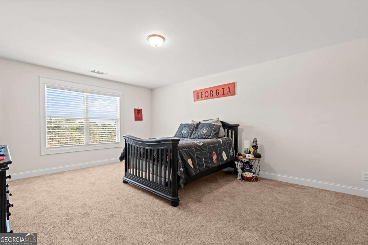 1515 Pleasant Ridge Road Carrollton, GA 30117 - Photo 45 of 72 a bedroom with a bed and a window