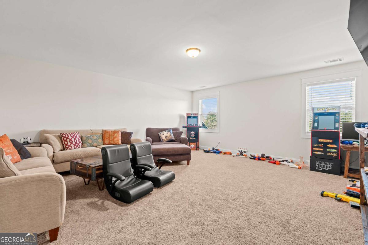 1515 Pleasant Ridge Road Carrollton, GA 30117 - Photo 47 of 72 a living room with furniture a couch and dresser