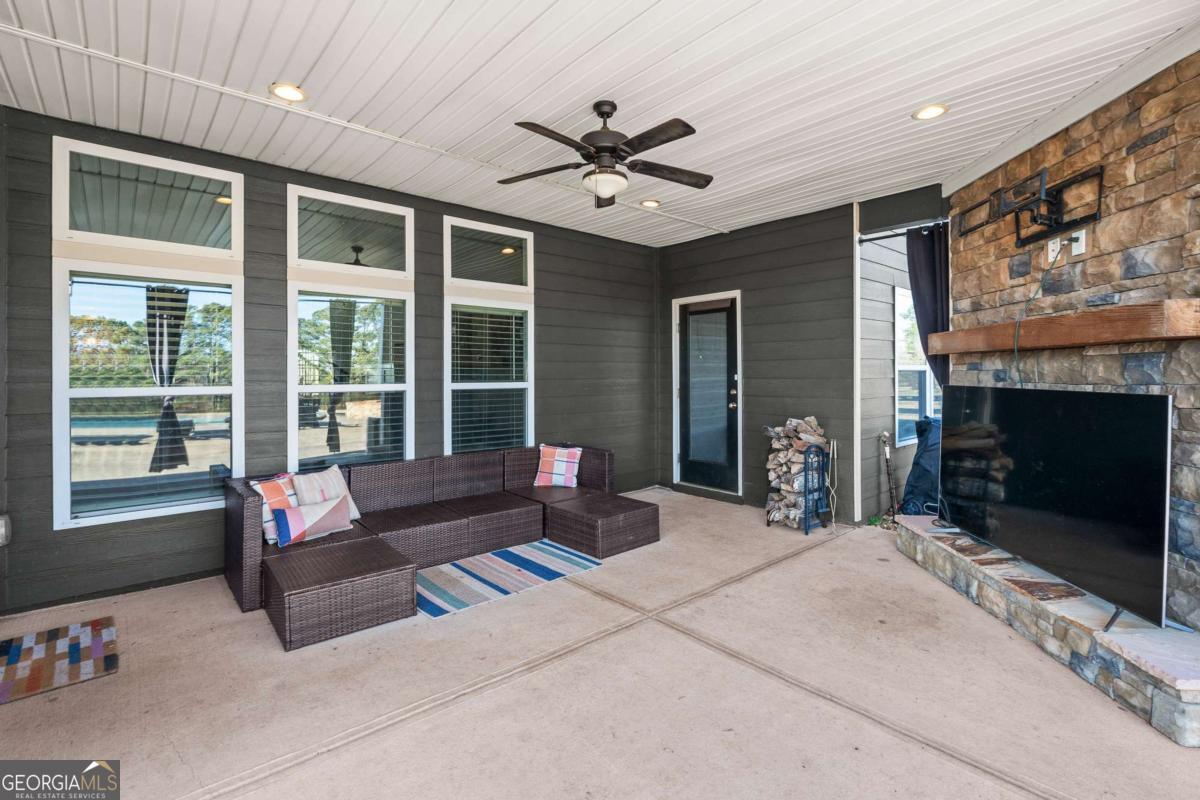1515 Pleasant Ridge Road Carrollton, GA 30117 - Photo 49 of 72 a living room with furniture large window and a fireplace