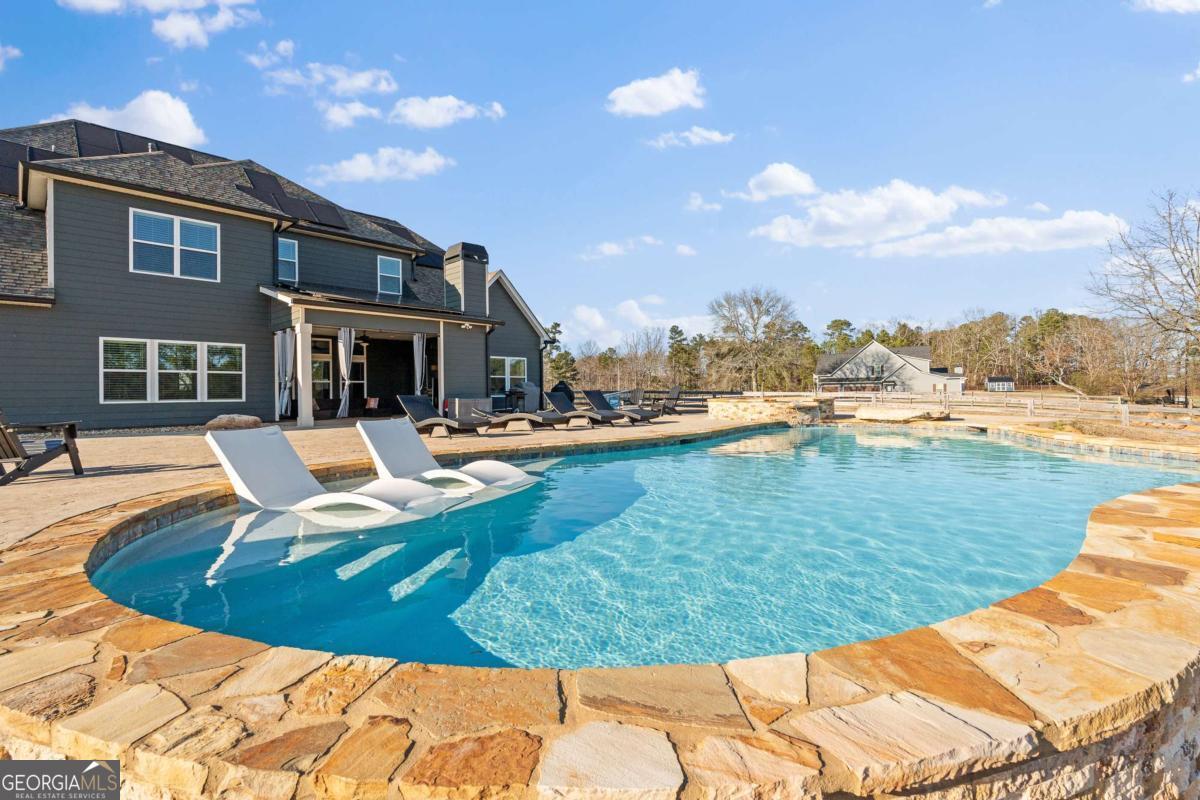 1515 Pleasant Ridge Road Carrollton, GA 30117 - Photo 55 of 72 a view of a swimming pool with lawn chairs