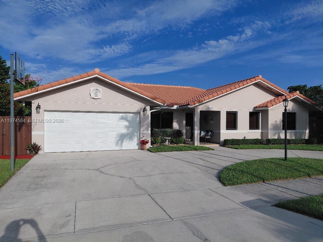a front view of a house with a yard and garage
