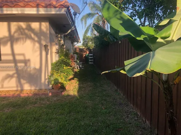 a backyard of a house with table and chairs
