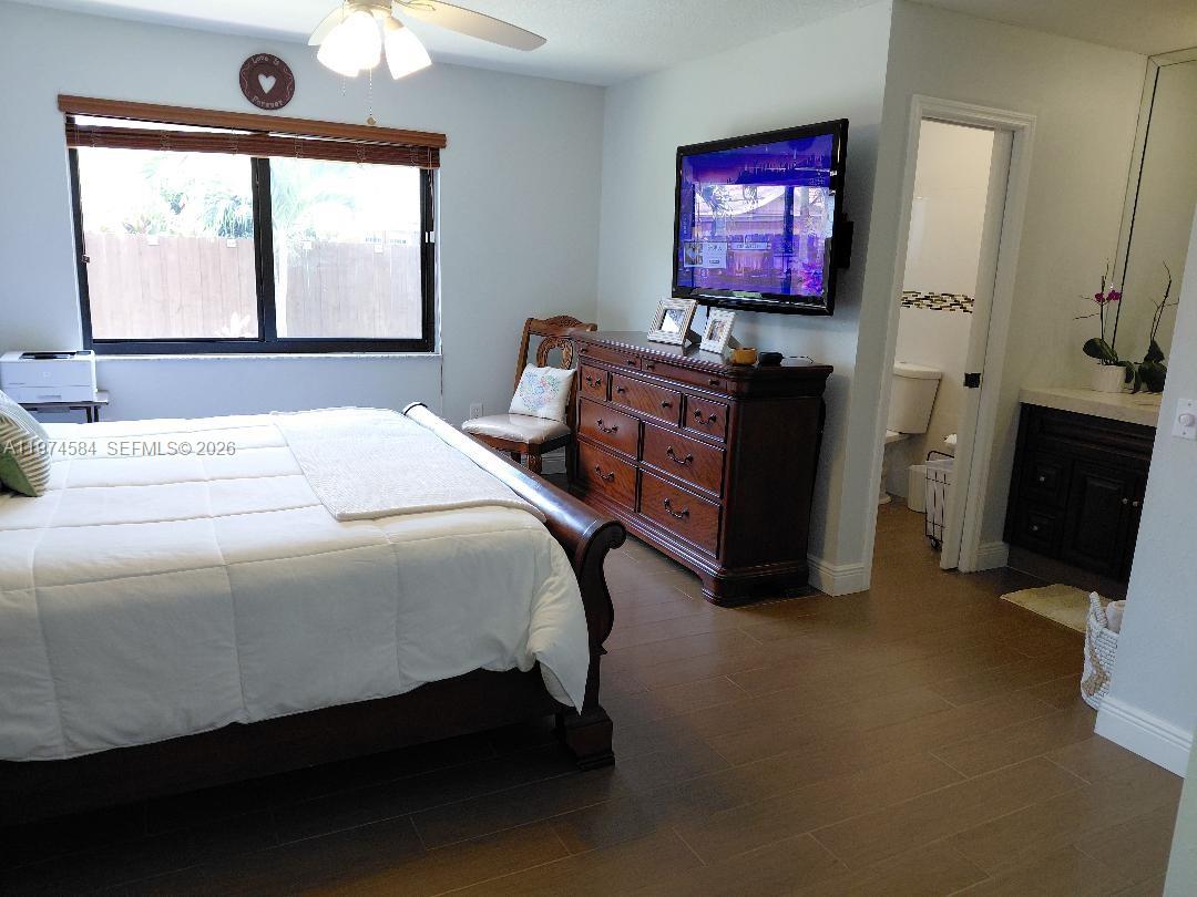 15630 Southwest 146th Avenue Miami, FL 33177 - Photo 15 of 23 a bed sitting in a bedroom next to a window